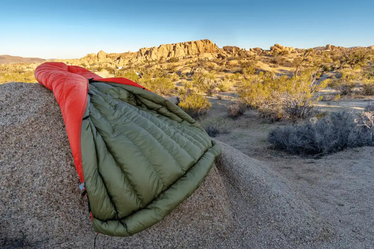 High quality UGQ Bandit quilt on a rock in the desert, opened to showcase the baffles and overall build quality