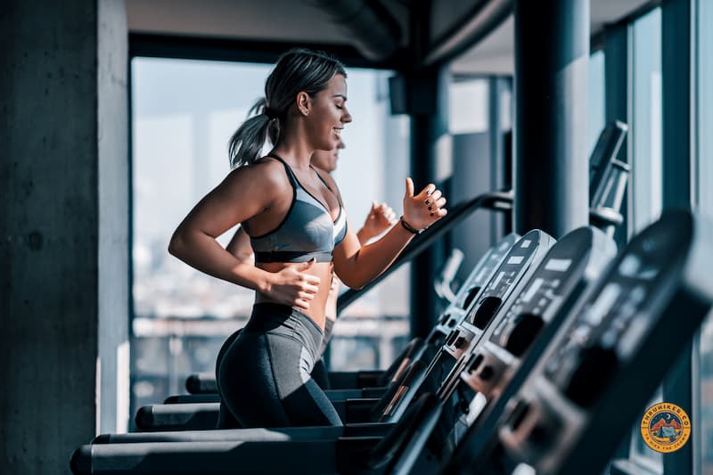 Woman running on a treadmill getting her cardio built up in the gym