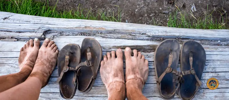 Dirty feet and sandals for a man and women
