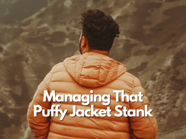 Man with an orange puffy jacket in the mountains