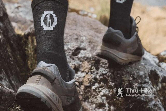 Hiker wearing a pair of 3/4 PAKA socks in their trail runners