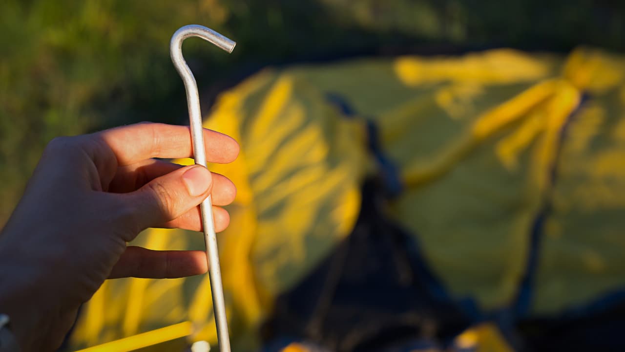 Man holding a sheperd Tent Stake